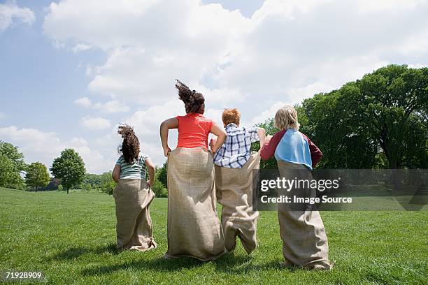 kids having a sack race - sack race stock pictures, royalty-free photos & images