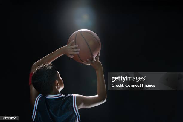 illuminated boy with basketball - kids basketball team stock pictures, royalty-free photos & images