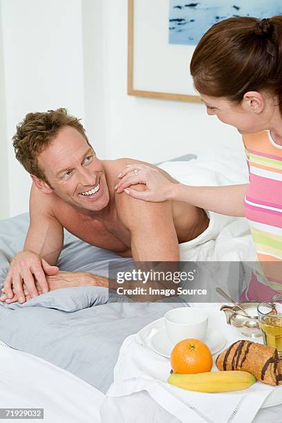 woman bringing breakfast to husband - apple juice stock pictures, royalty-free photos & images