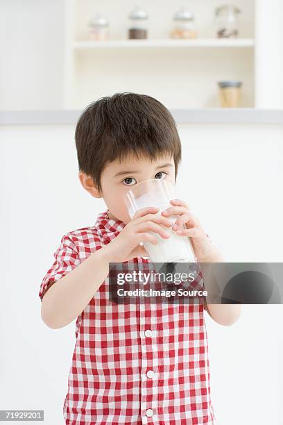 asian boy drinking milk - boy drinking milk stock pictures, royalty-free photos & images