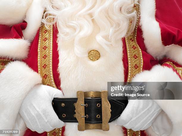 santa holding onto belt - gold belt stock pictures, royalty-free photos & images