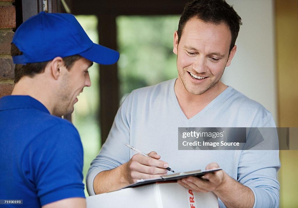 Courier delivering a package to man