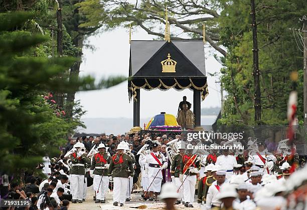 The casket carrying The Late King Taufa'ahau Tupou IV proceeds down the road toward the burial site during the State Funeral for King Taufa'ahau...