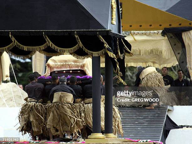 The bearer party convey the casket holding the body of Tonga's King Taufa'ahau Tupou IV to the royal tomb in the royal burial grounds of Nuku'alofa...