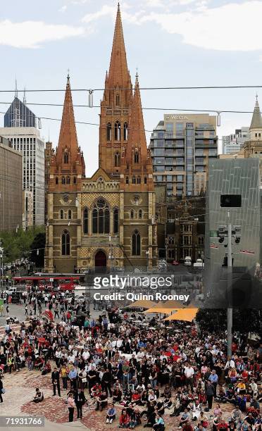 Peter Brock fans watch the telecast of the state funeral for Peter Brock held at St Paul's Cathedral while standing in Federation square September...