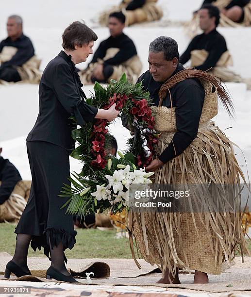 New Zealand's Prime Minister Helen Clark delivers a wreath to the royal undertaker for the tomb of the late King Taufa'ahau Tupou IV at his state...