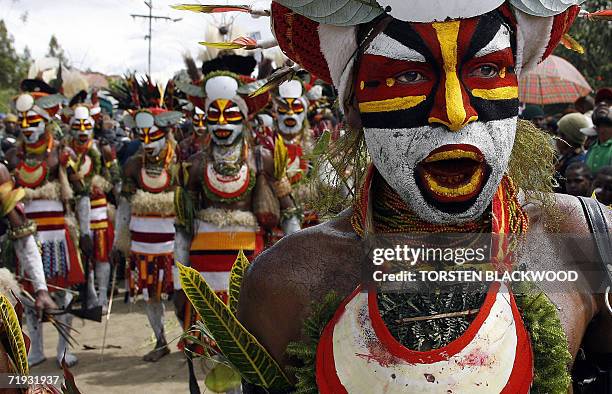 Goroka, PAPUA NEW GUINEA: Nebilyer warriors march through town towards the 50th Goroka singsing in what is believed to be the largest gathering of...