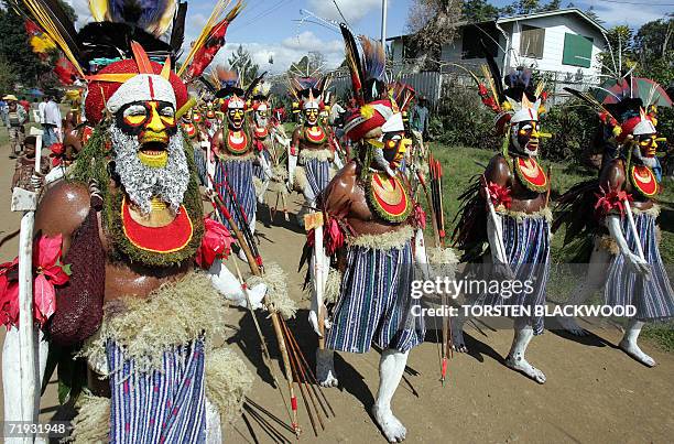 Goroka, PAPUA NEW GUINEA: Tepoka warriors from the Western Highlands march towards the 50th Goroka singsing in what is believed to be the largest...