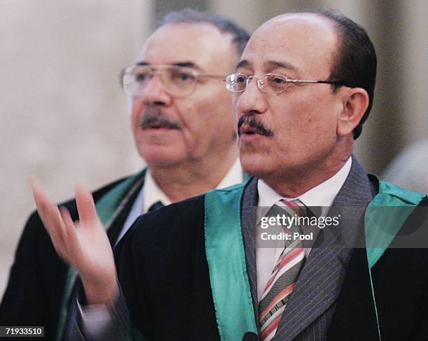 Defence lawyer Wadood Fawzi gestures beside fellow defence lawyer Badie Aref during the trial of former Iraqi President Saddam Hussein on genocide...