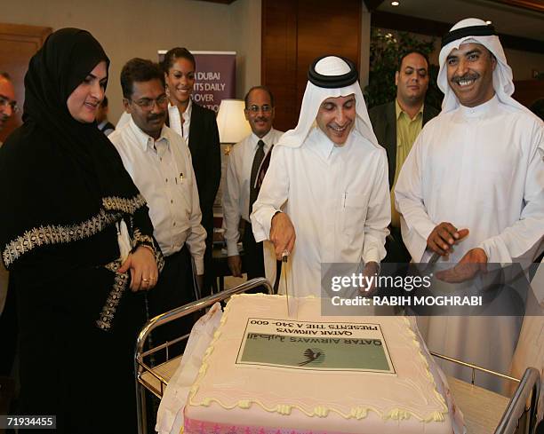 Dubai, UNITED ARAB EMIRATES: Qatar Airways chief executive officer, Akbar al-Baker , cuts the cake after a press conference held to launch the...