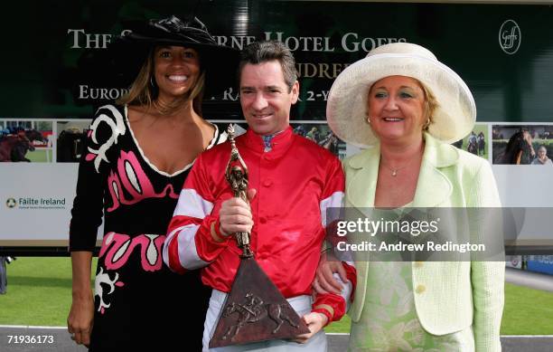 Melissa Lehman and and Glendryth Woosnam present winning jockey Michael Hills with his trophy after the third race during the Ryder Cup Wives Race...