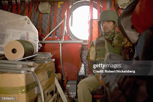 An Afghan interpreter rides in a US Army CH-47 helicopter on his way to Forward Operating Base Mizan in Zabul Province, Afghanistan September 14,...