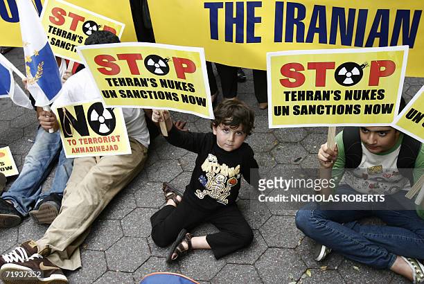 New York, UNITED STATES: Kian Sahafamin of San Diego, holds a sign at a protest against Iranian President Mahmoud Ahmadinejad at Dag Hammarskjold...