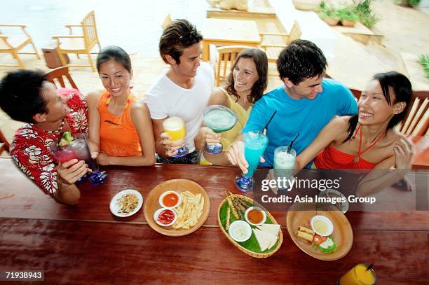 young adults at beach bar, high angle view - high hair bun stock pictures, royalty-free photos & images