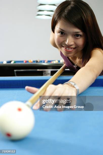 woman with pool cue, aiming at ball - pool table moving stock pictures, royalty-free photos & images