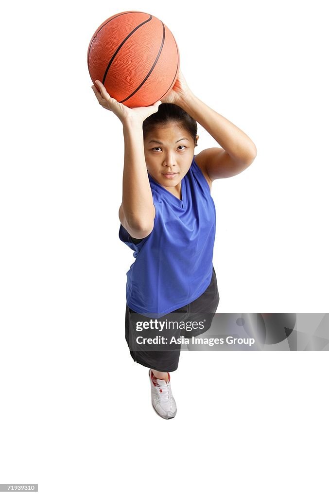 Young woman with basketball, aiming for a shoot