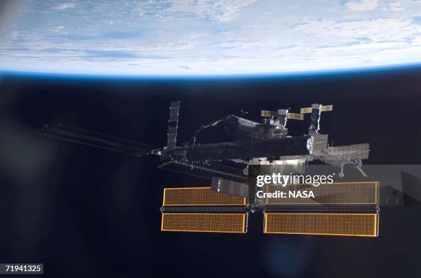 In this handout photo provided by NASA, This view of the International Space Station over a blue and white Earth was taken shortly after the Space...