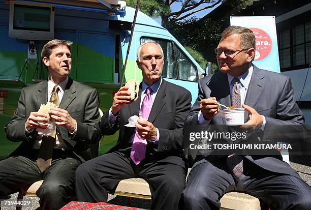 Meat Export Federation chairman John Bellinger , USMEF president and CEO Philip Seng and MSMEF Japan director Gregory Hanes eat US beef sandwiches...