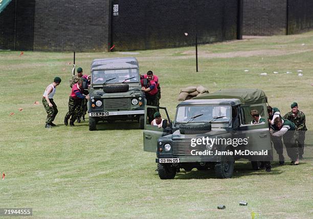 The England rugby team push army Landrovers during training with the Royal Marines at Lympstone, Devon, 28th July 1999.