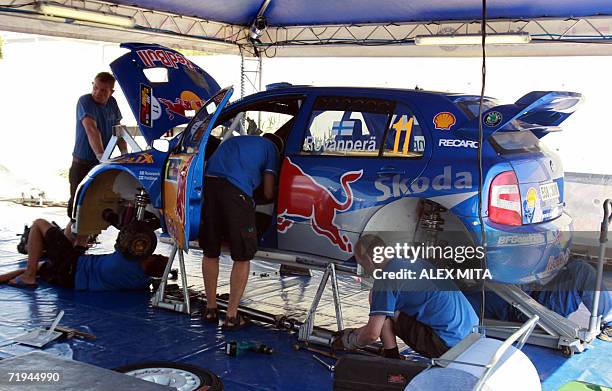 Mechanics of the Skoda team prepare Finnish driver Harri Rovanpera's car at the service area of the Palais de Sport in the sourthern Cypriot port of...