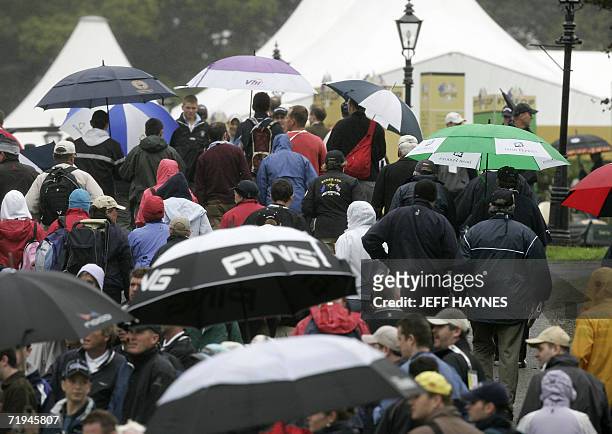 Ryder Cup golf fans shelter under umbrella's as they enter the course on the second practice day for the Ryder Cup competition at the K Club in Co...