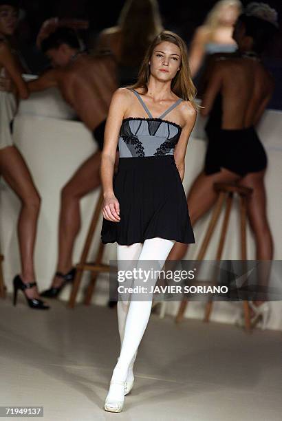 Model displays an outfit by Spanish designer Lydia Lozano, part of her Spring/Summer 2007 collection at Madrid fashion week, 20 September 2006. AFP...