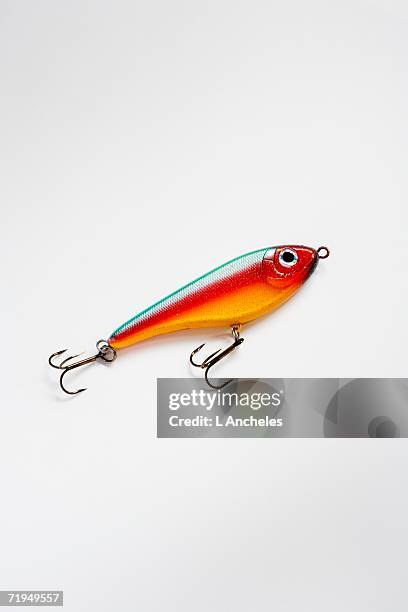 a lure on a white background. - fishing hook stock-fotos und bilder