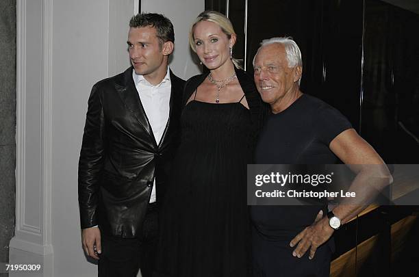 Chelsea football player Andriy Shevchenko and his wife Kristen Pazik with Giorgio Armani pose for cameras outside the new Armani Casa store as they...