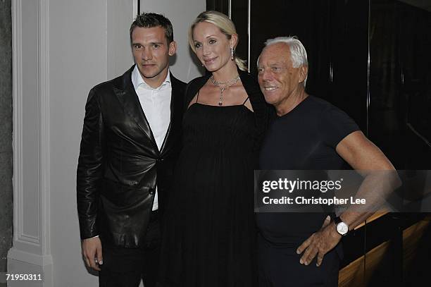 Chelsea football player Andriy Shevchenko and his wife Kristen Pazik with Giorgio Armani pose for cameras outside the new Armani Casa store as they...