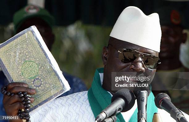 Gambia's President and leader of the Alliance for Patriotic Reorientation and Construction party, Yahya Jammeh, holds the Koran during a presidential...