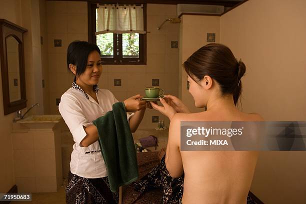 young woman and massage therapist - bali massage ストックフォトと画像