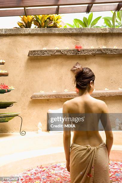 young woman taking bath with flower petals - japanese women bath stock pictures, royalty-free photos & images