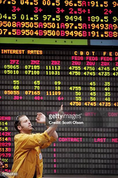 Greg Kern signals prices from the Eurodollar options pit at the Chicago Mercantile Exchange following the announcement from the Federal Open Market...