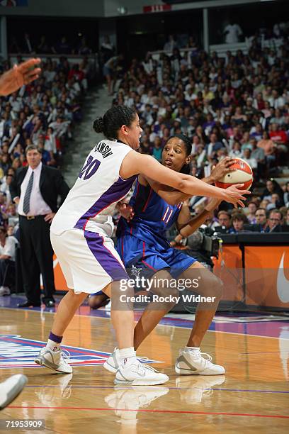 Kedra Holland-Corn of the Detroit Shock battles to pass the ball against Kara Lawson of the Sacramento Monarchs in game four of the 2006 WNBA Finals...