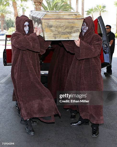 Druid characters carry a coffin holding Twisted Sister singer Dee Snider into the Hard Rock Hotel & Casino en route to a news conference September...