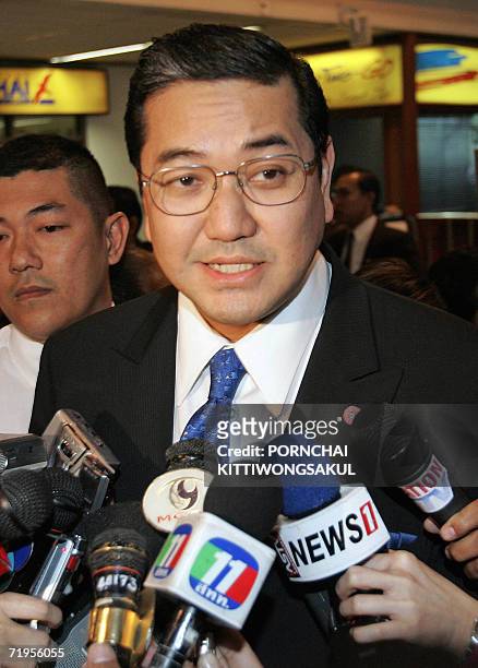 Thai Deputy Minister Surakiart Sathirathai answers questions from the press as he arrives at the international airport in Bangkok, 21 September 2006....
