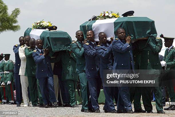 The bodies of ten Nigerian army generals and three others that died in an air crash are carried by pall bearers for burial at the military national...