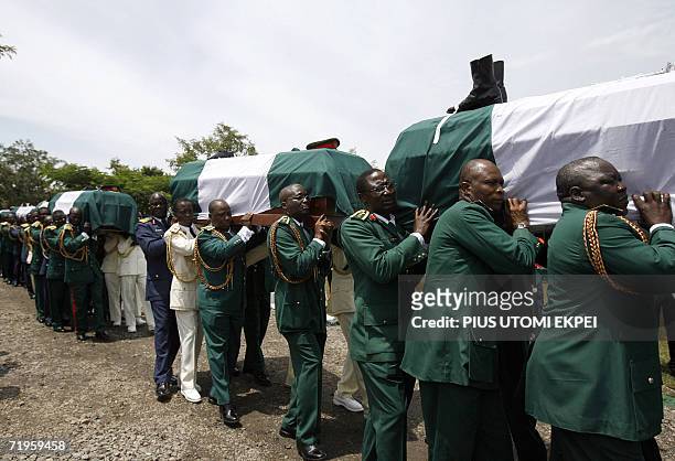 The bodies of ten Nigerian army generals and three others that died in an air crash are carried by pall bearers for burial at the military national...
