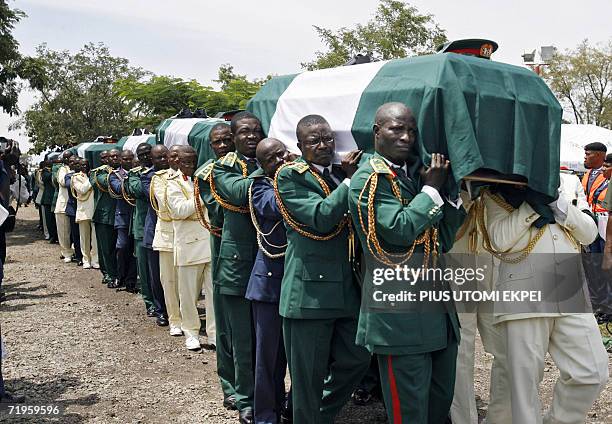 The bodies of ten Nigerian army generals and three others that died in an air crash being carried by pall bearers for burial 21 September 2006 at the...