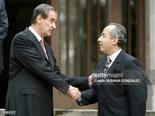 Mexican President Vicente Fox shakes hands with president elect Felipe Calderon at Los Pinos residence, 21 September 2006, during a meeting of...