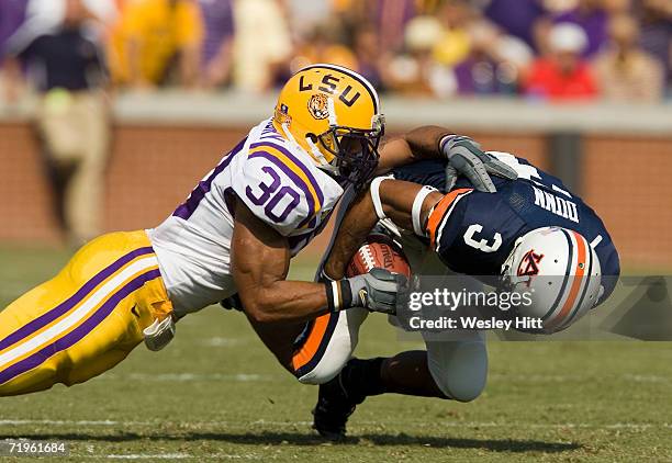 Wide receiver Robert Dunn of the Auburn Tigers gets tackled by safety LaRon Landry of the LSU Tigers during a game on September 16, 2006 at...