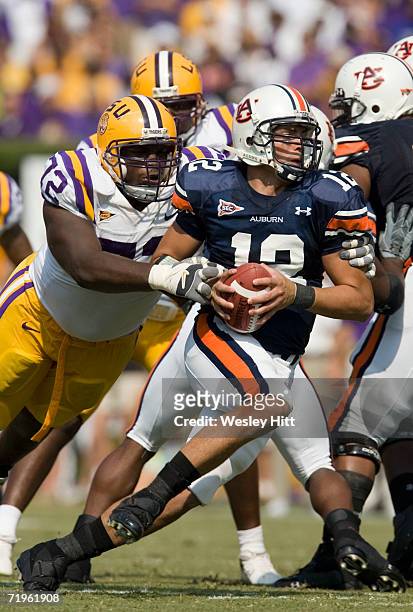 Quarterback Brandon Cox of the Auburn Tigers is grabbed by defensive tackle Glenn Dorsey of the LSU Tigers during a game against the LSU Tigers on...