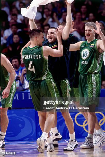 Sarunas Jasikeviicius of the Lithuanian National Team receives high fives from his teammates against the Yugoslavian National Team during the 2000...