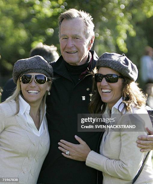 Ex-President of the United States, George Bush poses for a photograph with Amy Mickelson and Amy DiMarco, partners of Ryder Cup members Phil...