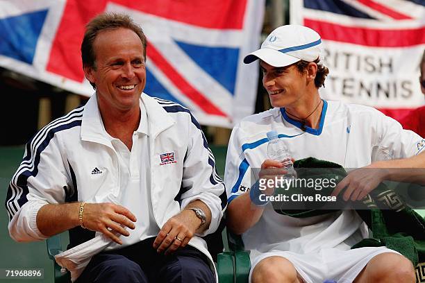 Andy Murray of Great Britainshares a joke with team captain John Lloyd during his second rubber match against Aleksandr Dolgopolov of Ukraine in the...