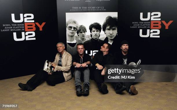 Adam Clayton, Larry Mullen Jr, Bono and The Edge of rock group U2 appear at a signing of their new book "U2 by U2" at Waterstone?s Piccadilly on...