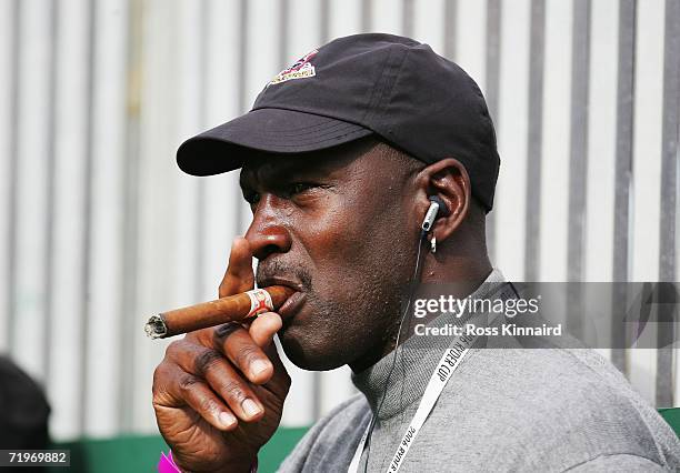 Michael Jordan smokes a cigar and watches the action during the morning fourballs of the first day of the 2006 Ryder Cup at The K Club on September...