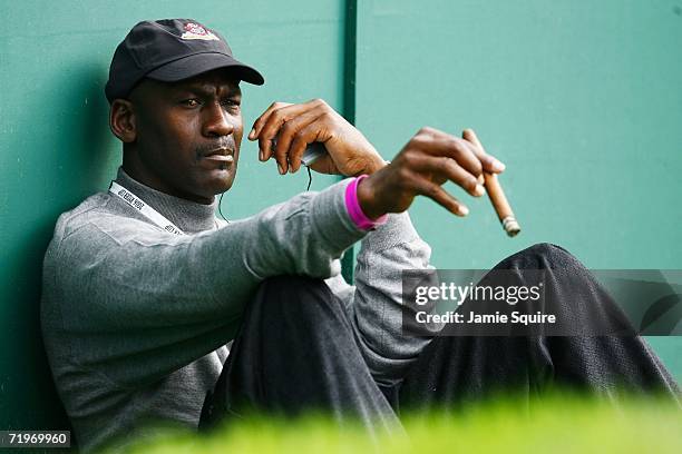 Michael Jordan smokes a cigar and watches the action during the morning fourballs of the first day of the 2006 Ryder Cup at The K Club on September...