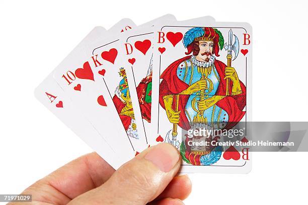 person holding royal flush of hearts suit, close-up - jack of hearts stock-fotos und bilder