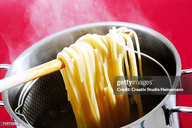 spaghetti in cooking pot, elevated view - boiling pasta stock pictures, royalty-free photos & images